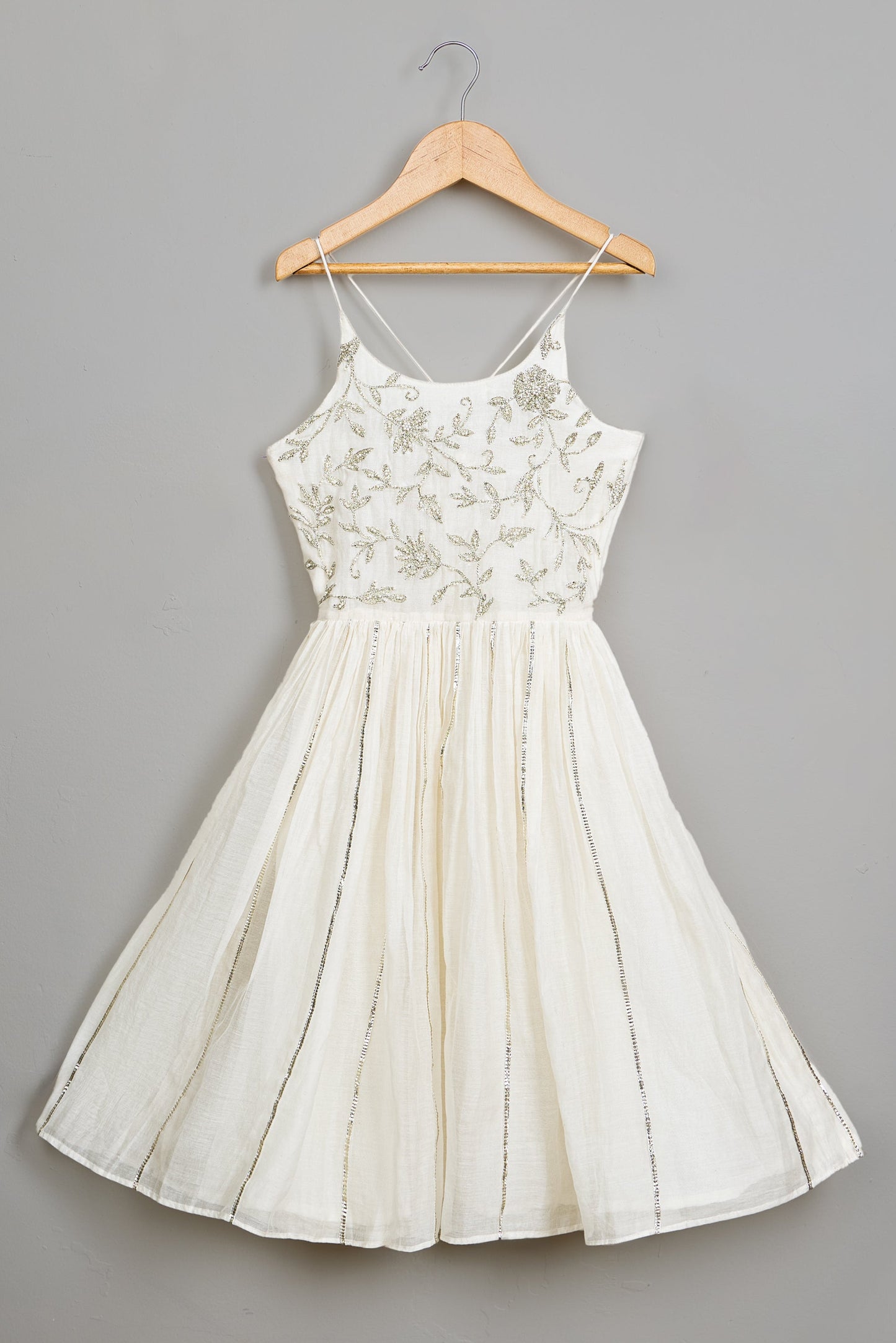 White dress on a hanger against a gray background